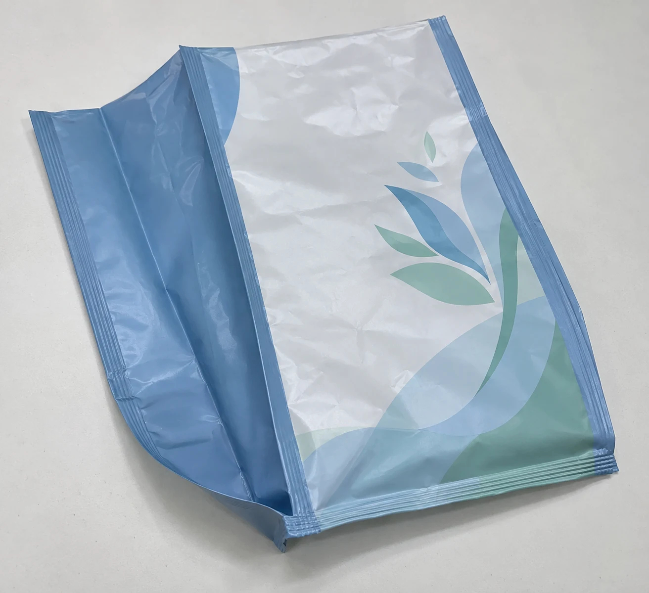 Flat empty quad seal gusset bags with care artwork